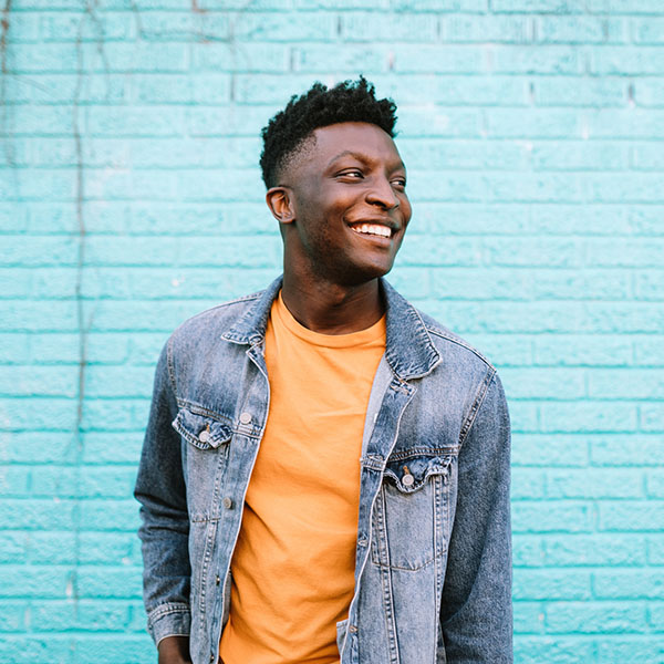cheerful fashionable adult man in city setting