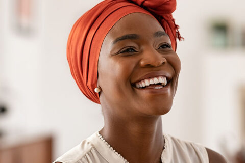 Cheerful african woman wearing trendy red headscarf